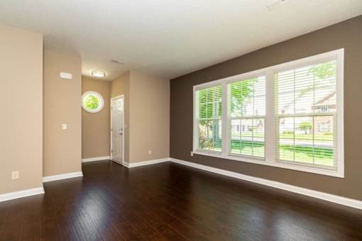 A room with brown walls and a wooden floor.