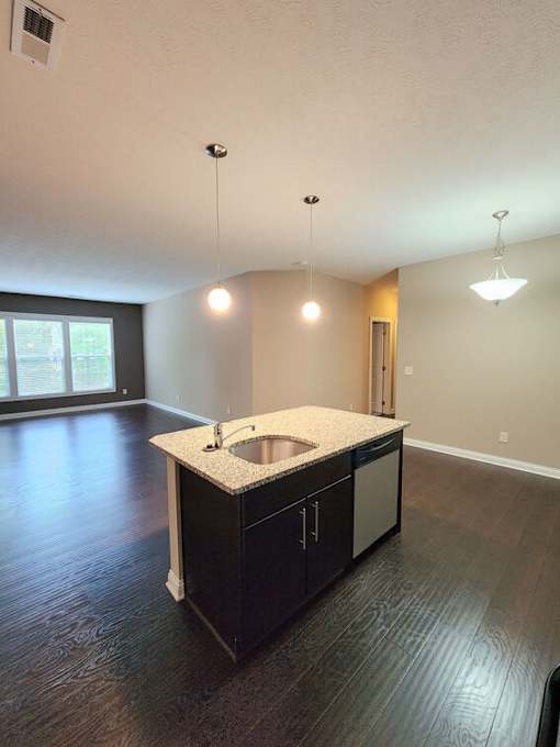 A kitchen with a sink and cabinets.