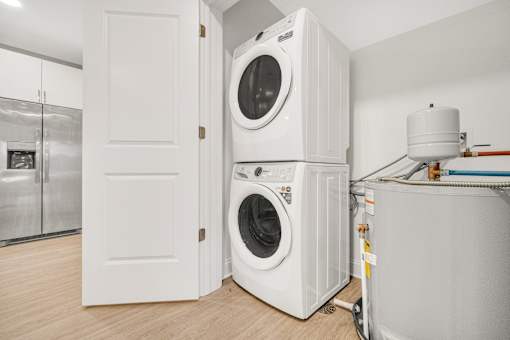 A white washing machine is in a small room. at Park Lamont Townhomes Apartments, Ohio