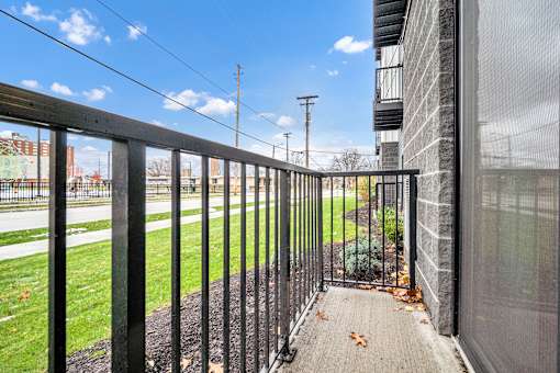 A black metal fence leads to a building entrance. at Park Lamont Townhomes Apartments, Cleveland, Ohio