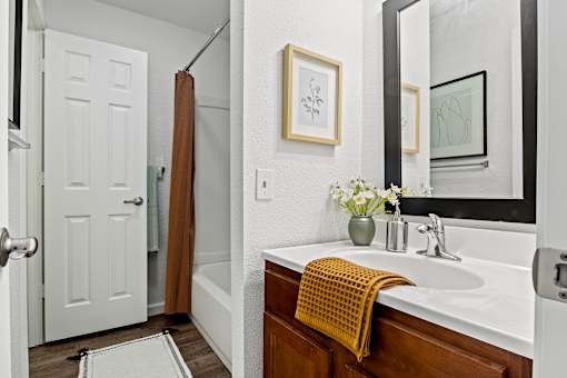 A bathroom with a white sink and a yellow towel. at Vivo Toledo Apartments, Ohio
