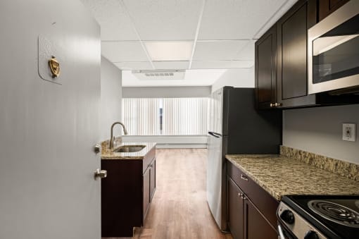 redesigned kitchen with granite countertops and stainless steel appliances and a window
