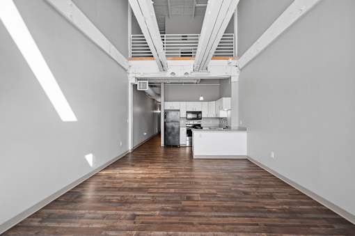 A long hallway with a kitchen at the end.