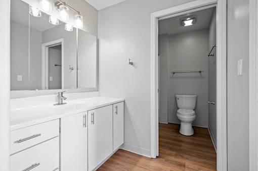 A white bathroom with a toilet and a sink.