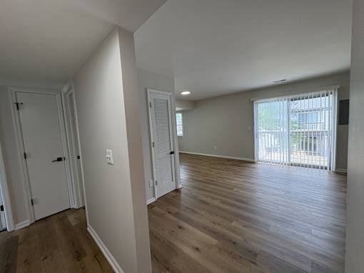 A room with wooden floors and white walls.