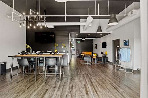 A modern dining area with a long table and chairs. at Vivo Toledo Apartments, Toledo, Ohio