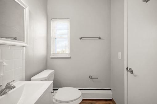a bathroom with a toilet sink and a window