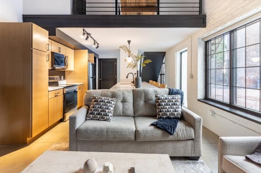 modern living room with a grey couch at Life At Agora, Cleveland, OH 44103  