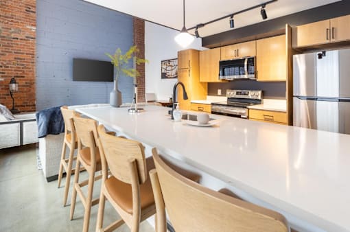 white counter and wooden chairs at Life At Agora, Cleveland, 44103