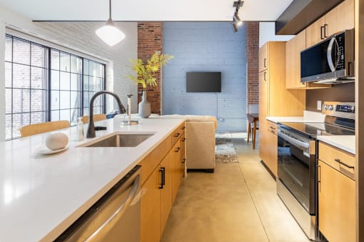 Kitchen with long white countertop at Life At Agora, Cleveland, OH