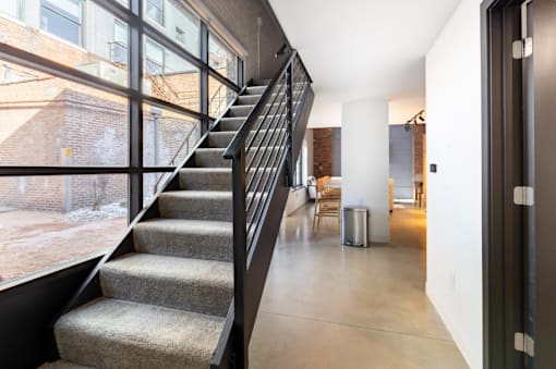 staircase with a metal railing at Life At Agora, Cleveland