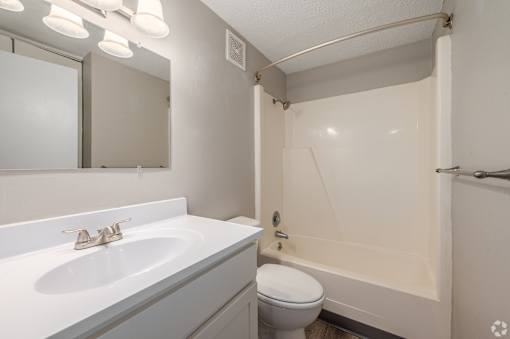 a bathroom with a tub and shower