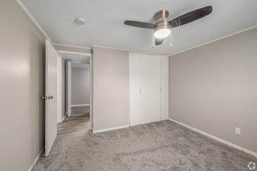 a bedroom with a ceiling fan