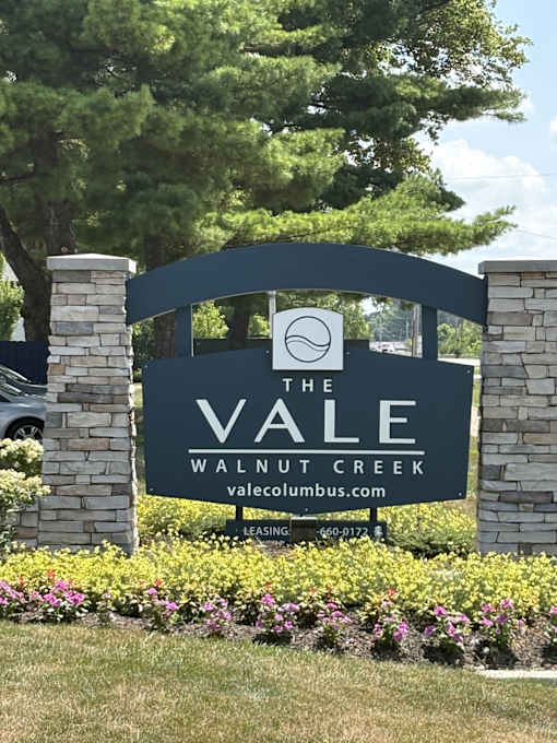 A sign for The Vale Walnut Creek is shown in front of a green tree.