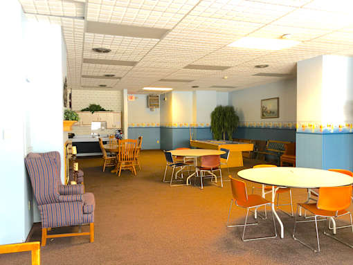 A room with a table and chairs.