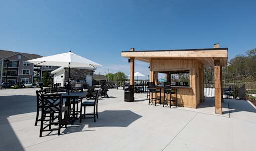an outdoor patio with tables and chairs and a bar at The Bend, Lancaster