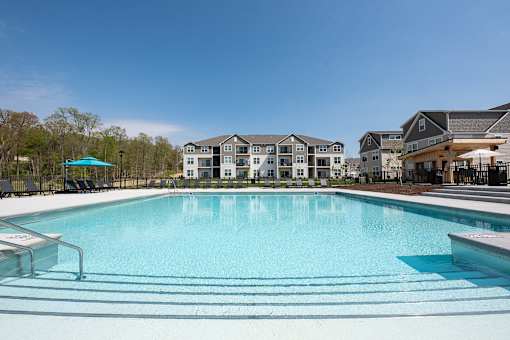 a swimming pool with apartments in the background at The Bend, Lancaster, Ohio