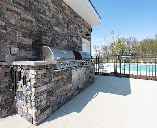 the outdoor grill area of a house with a swimming pool at The Bend, Lancaster