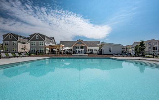 a large swimming pool with apartments in the background at The Bend, Ohio, 43130