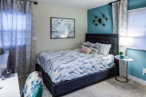 Bedroom With Expansive Windows at Heritage Apartments, Ohio