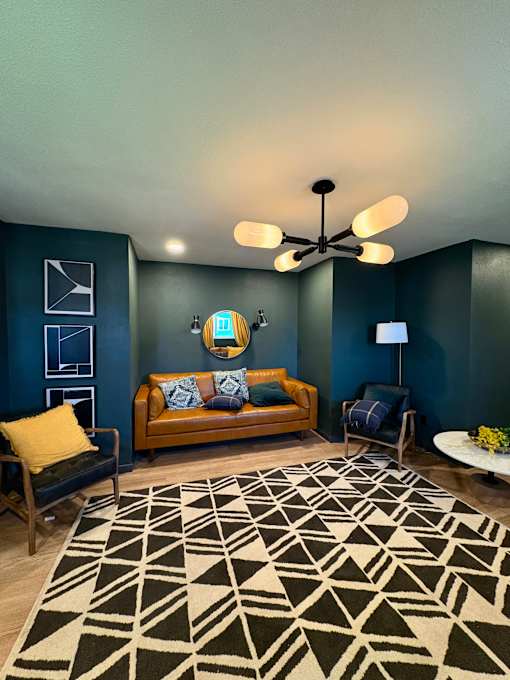A living room with a couch, a chair, and a rug. at Vivo Toledo Apartments, Toledo