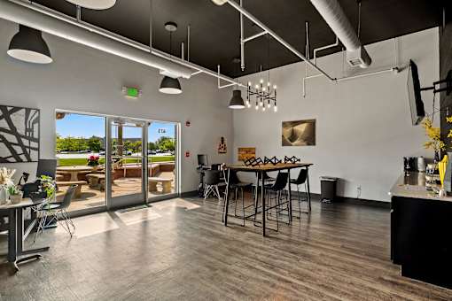 A modern kitchen with a dining table and chairs. at Vivo Toledo Apartments, Ohio, 43607
