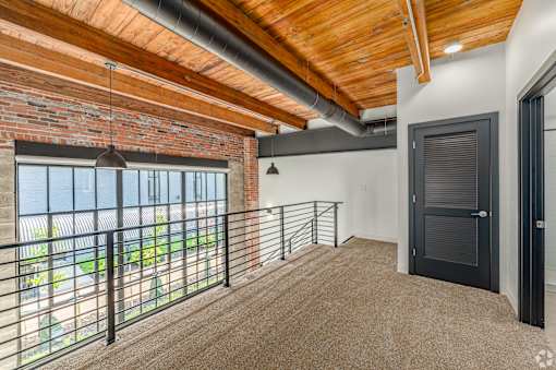 A room with a balcony and a black door at Life At Agora, Cleveland, OH