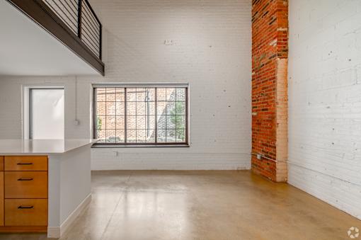 A room with a window and a brick wall at Life At Agora, Cleveland, OH