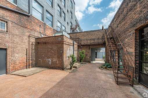 brick building with a gate at Life At Agora, Cleveland  