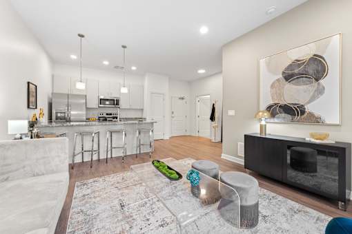 A modern kitchen with a white sofa and a grey rug. at The Lumos Apartments, Ohio