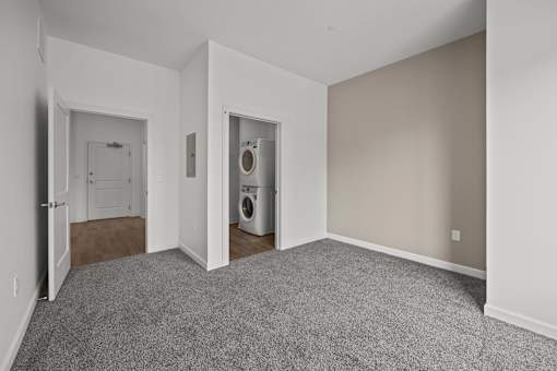 A room with a washer and dryer in it. at The Lumos Apartments, Ohio