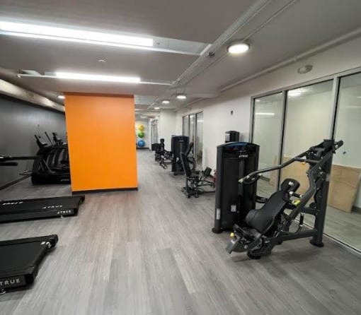 a room with a bunch of exercise equipment in it