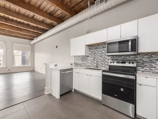 a kitchen with a stove top oven and a microwave