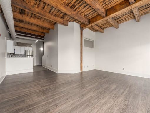 an empty room with white walls and a wooden ceiling