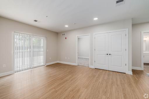 A large empty room with wooden floors and white walls. at Park Lamont Townhomes Apartments, Cleveland, OH