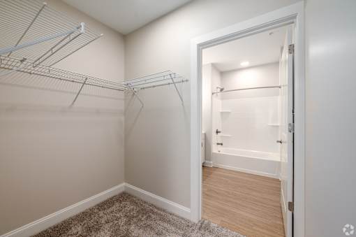 A white closet with a doorway leading to a bathroom. at Park Lamont Townhomes Apartments, Cleveland, OH, 44106