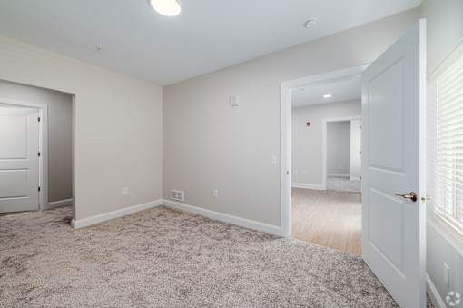 A room with a carpeted floor and white walls. at Park Lamont Townhomes Apartments, Ohio, 44106