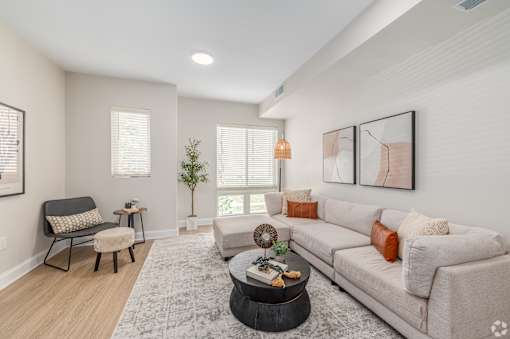 A living room with a couch, chair, and coffee table. at Park Lamont Townhomes Apartments, Cleveland, OH