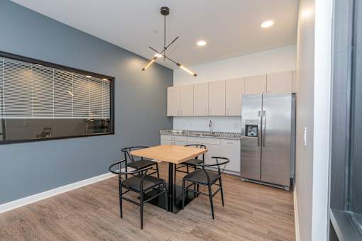 A kitchen with a table and chairs. at The Lumos Apartments, Cleveland 44106