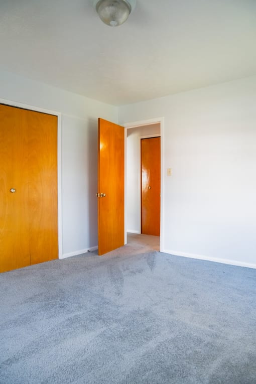 an empty room with two doors in it