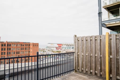 the view of the city from the deck of a building with a fence