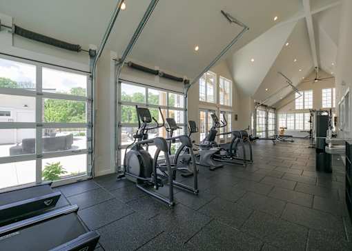 the gym has plenty of cardio equipment and large windows at The Bend, Lancaster, OH