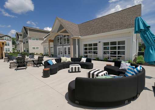 a patio with couches and tables outside of a building at The Bend, Lancaster, OH