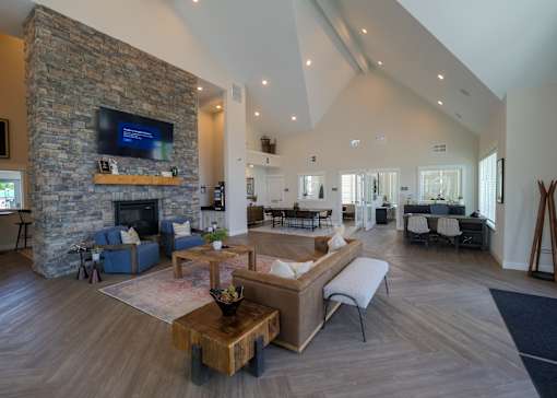 a large living room with a stone fireplace and a television at The Bend, Lancaster, OH, 43130