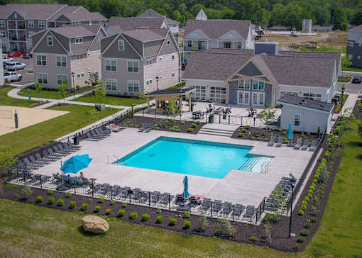 an aerial view of a swimming pool in front of an apartment building at The Bend, Lancaster, Ohio