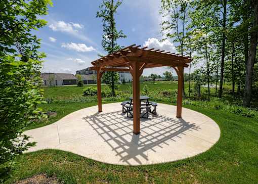 a patio with a picnic table and a wooden pavilion at The Bend, Lancaster