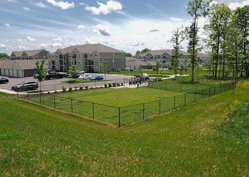 a park with a tennis court in front of an apartment building at The Bend, Ohio, 43130