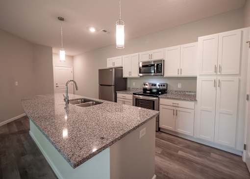 a kitchen with granite counter top and stainless steel appliances at The Bend, Lancaster, OH