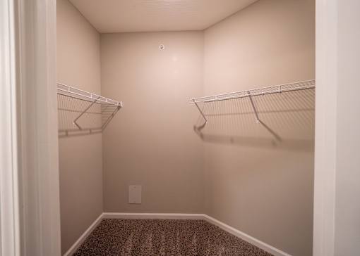 an empty closet with two hanging rails in a home at The Bend, Lancaster