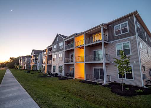 a row of town houses with a sidewalk in front of them at The Bend, Lancaster, OH